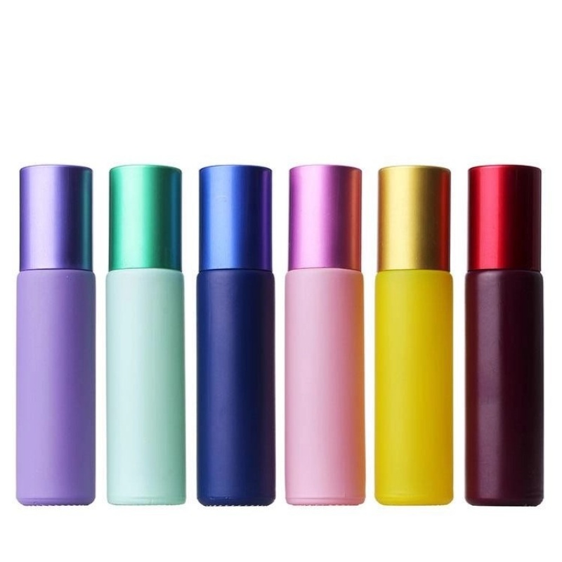 Factory wholesale colored perfume and essential oil glass bottles in various styles, including frosted rollerball bottles.