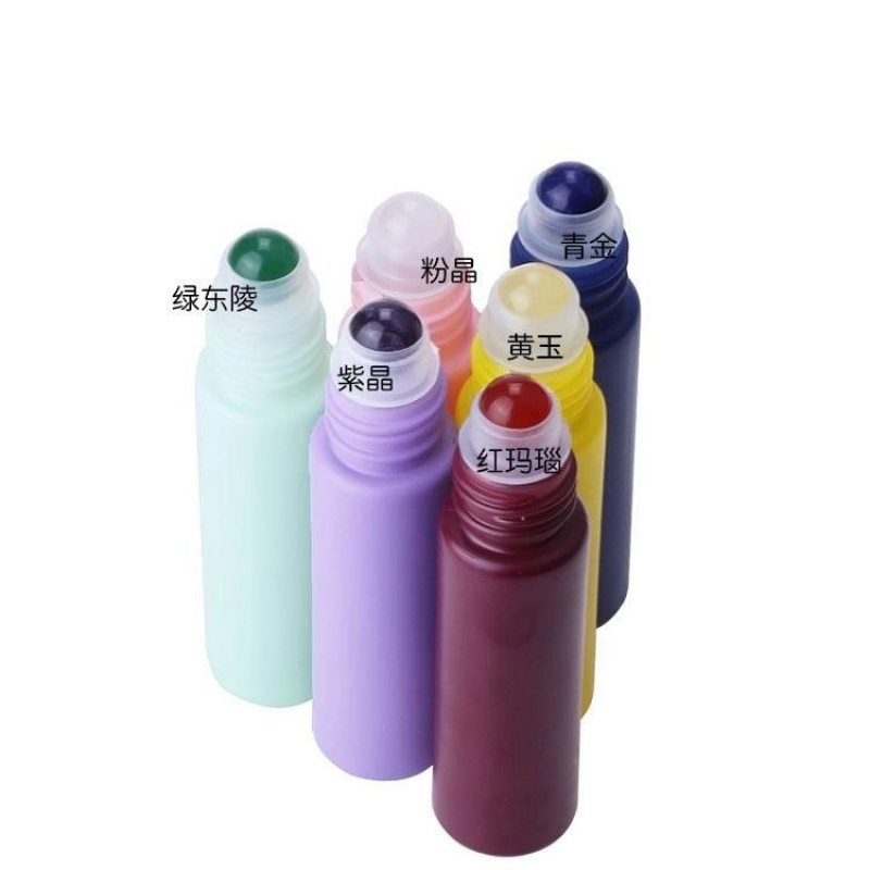 Factory wholesale colored perfume and essential oil glass bottles in various styles, including frosted rollerball bottles.